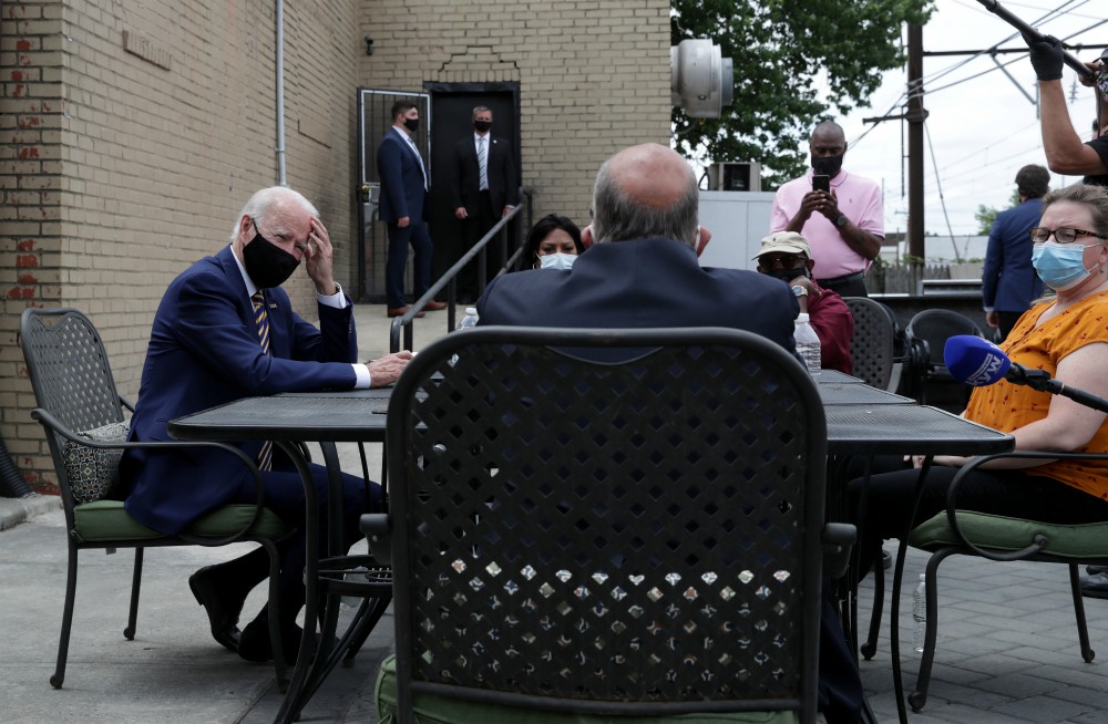 Joe Biden talks with local residents about the effects of the COVID-19 pandemic on their small businesses, on the outside patio of the Carlette's Hideaway sports bar during a campaign stop in Yeadon, Pennsylvania, on June 17. (CNS/Reuters/Jonathan Ernst)
