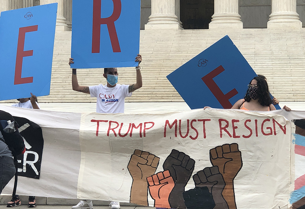 Supporters of the Deferred Action for Childhood Arrivals program hold signs and cheer at the Supreme Court in Washington June 18, 2020, after justices handed down a 5-4 ruling rejecting then-President Donald Trump's executive order to cancel DACA. (CNS)