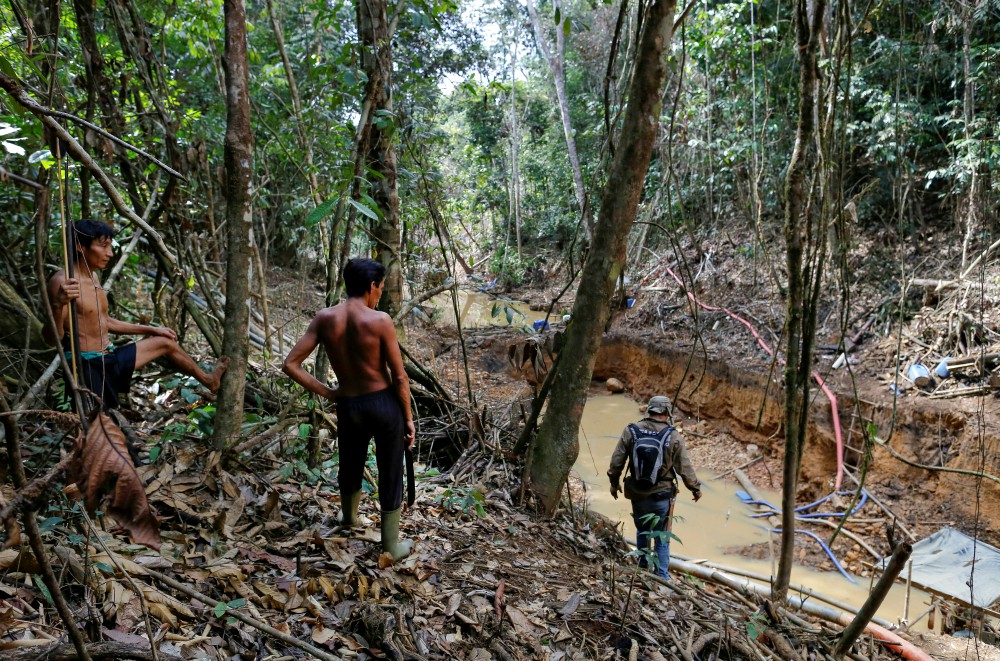 Yanomami are seen in a file photo following members of Brazil's environmental agency during an operation against illegal gold mining on indigenous land in the heart of the Amazon rainforest. (CNS/Reuters/Bruno Kelly) Yanomami are seen in a file photo following members of Brazil's environmental agency during an operation against illegal gold mining on indigenous land in the heart of the Amazon rainforest. (CNS/Reuters/Bruno Kelly)