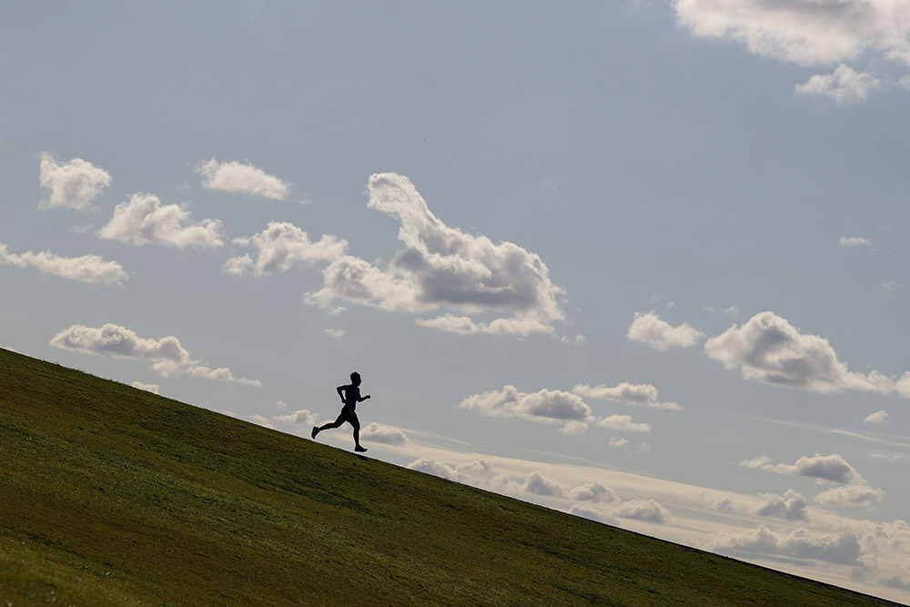 A runner in Australia is seen in Sydney Park June 26. (CNS/Loren Elliott, Reuters)
