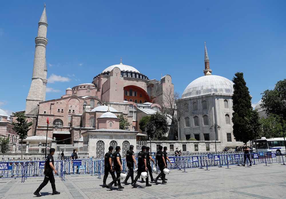 Turkish police officers walk in front of Hagia Sophia July 11 in Istanbul. (CNS/Reuters/Murad Sezer)