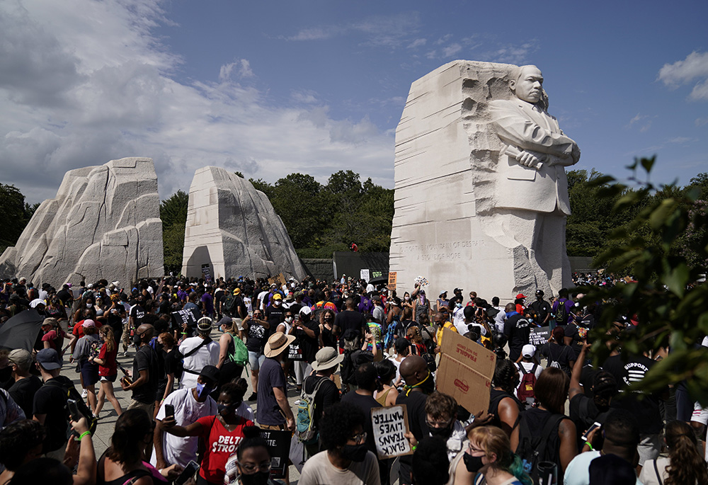 Demonstrators gather next to the Martin Luther King Jr. Memorial for the Aug. 28, 2020, "Get Your Knee Off Our Necks" March on Washington 2020 in support of racial justice. (CNS/Reuters/Erin Scott) Demonstrators gather next to the Martin Luther King Jr. Memorial for the Aug. 28, 2020, "Get Your Knee Off Our Necks" March on Washington 2020 in support of racial justice. (CNS/Reuters/Erin Scott)