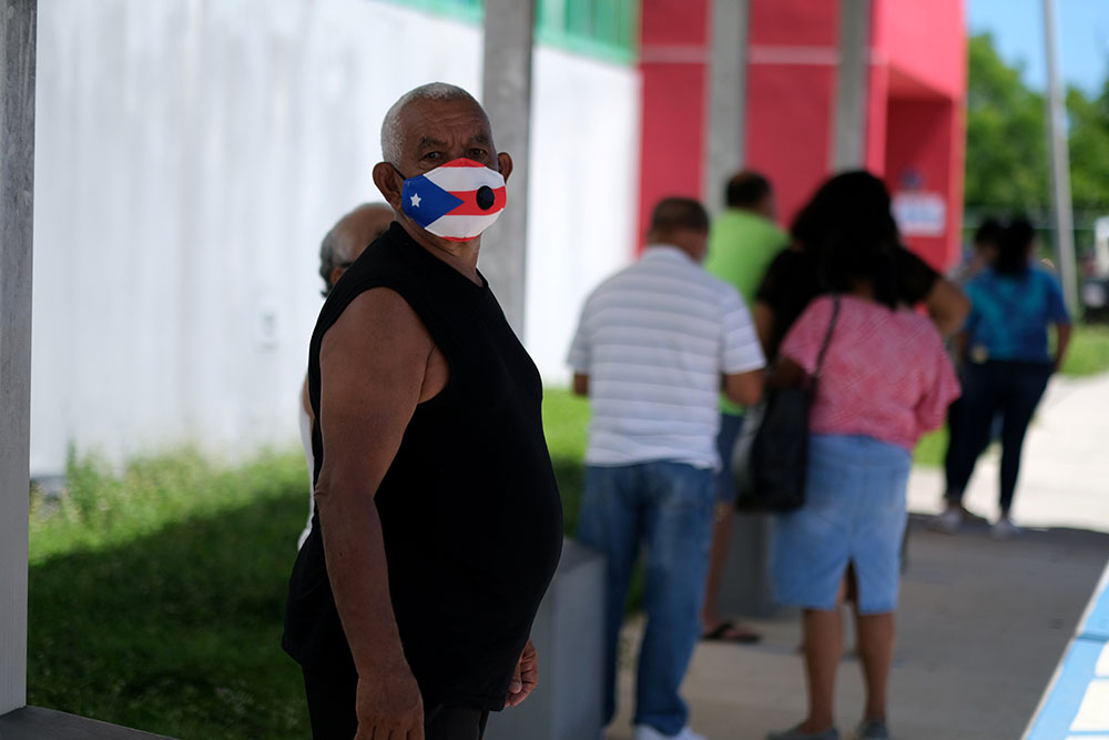 A voter in Loiza, Puerto Rico, waits to cast his ballot Aug. 16, 2020. (CNS/Reuters/Ricardo Arduengo)