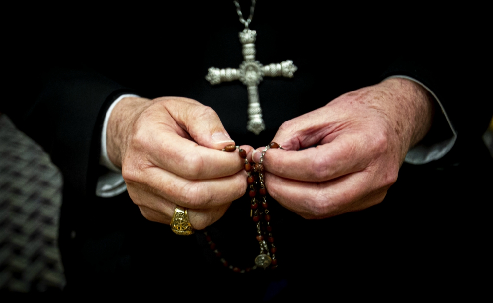 Los Angeles Archbishop José Gomez, now president of the U.S. Conference of Catholic Bishops, holds his rosary Nov. 10, 2019, in a Baltimore hotel where he attended the U.S. bishops' fall general assembly last year. (CNS/Chaz Muth)