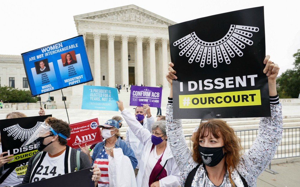 Demonstrators in Washington are seen near the Supreme Court building Oct. 13, during the Senate Judiciary Committee's confirmation hearing for President Donald Trump's nominee for the U.S. Supreme Court, Judge Amy Coney Barrett. (CNS/Reuters) Demonstrators in Washington are seen near the Supreme Court building Oct. 13, during the Senate Judiciary Committee's confirmation hearing for President Donald Trump's nominee for the U.S. Supreme Court, Judge Amy Coney Barrett. (CNS/Reuters)