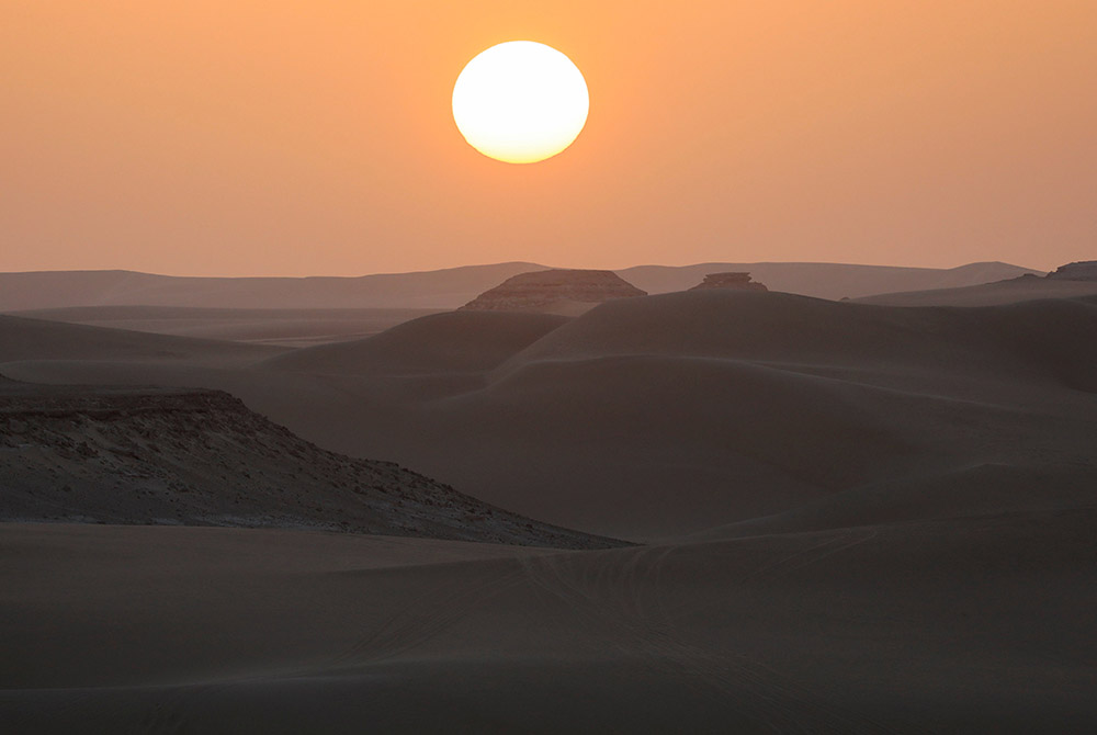 The sand dunes in Egypt's Western Desert are illuminated at sunset Oct. 15, 2020 in Siwa Oasis. (CNS/Amr Abdallah Dalsh, Reuters)