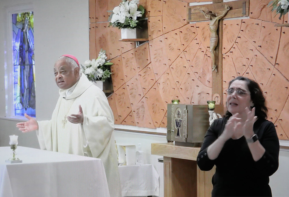 Washington Archbishop Wilton Gregory celebrates the White Mass at St. Francis Deaf Catholic Church Oct. 18, 2020, in Landover Hills, Maryland. Mary O'Meara interpreted the Mass in American Sign Language. (CNS/Screengrab via Catholic Standard) Washington Archbishop Wilton Gregory celebrates the White Mass at St. Francis Deaf Catholic Church Oct. 18, 2020, in Landover Hills, Maryland. Mary O'Meara interpreted the Mass in American Sign Language. (CNS/Screengrab via Catholic Standard)