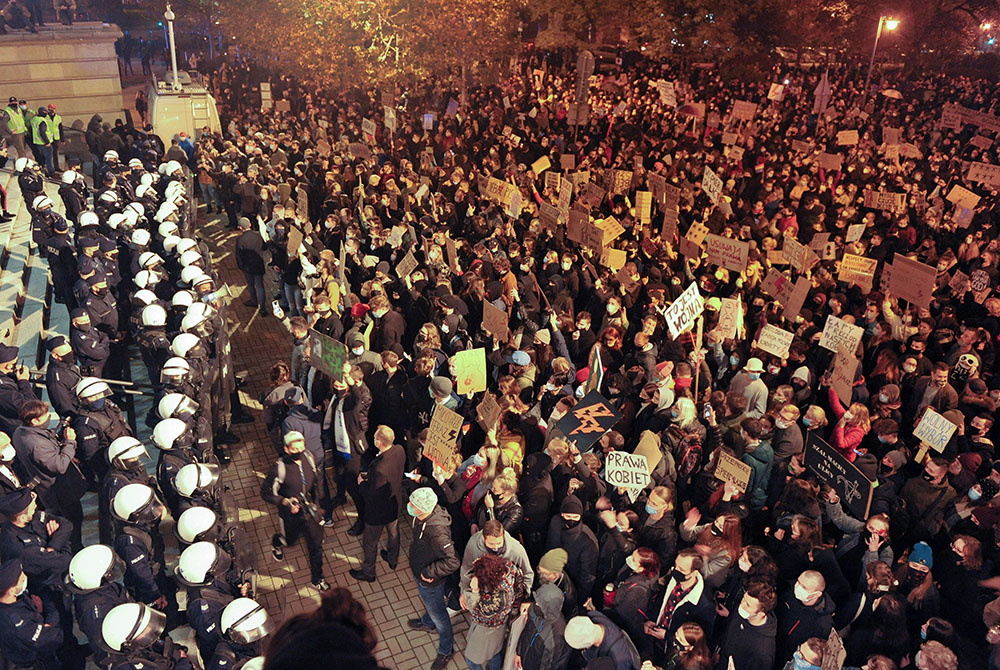 Demonstrators protest Oct. 25, 2020, in front of the Cathedral of Christ the King in Katowice, Poland, against the ruling by Poland's Constitutional Tribunal that imposes a near-total ban on abortion. Many young Polish women protested in November against Demonstrators protest Oct. 25, 2020, in front of the Cathedral of Christ the King in Katowice, Poland, against the ruling by Poland's Constitutional Tribunal that imposes a near-total ban on abortion. Many young Polish women protested in November against