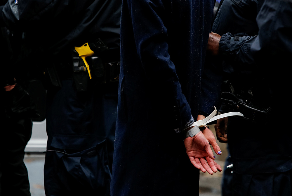 New York City police place a demonstrator in plastic handcuffs Nov. 1, 2020. (CNS/Eduardo Munoz, Reuters)
