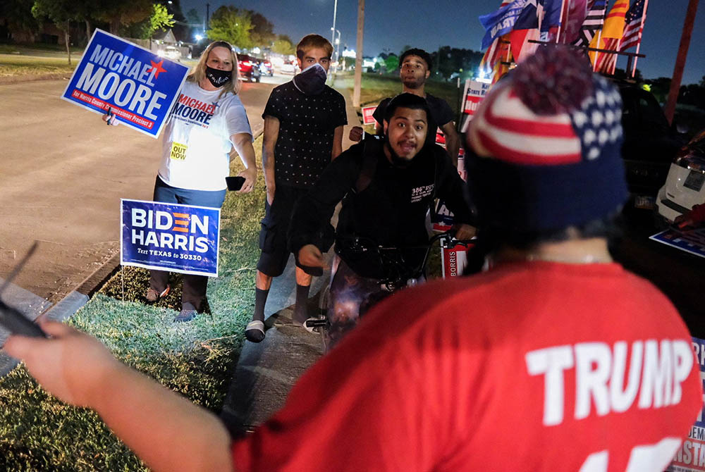 Joe Biden supporters face off with a President Donald Trump supporter outside a polling site in Houston Nov. 3. (CNS/Go Nakamura, Reuters)