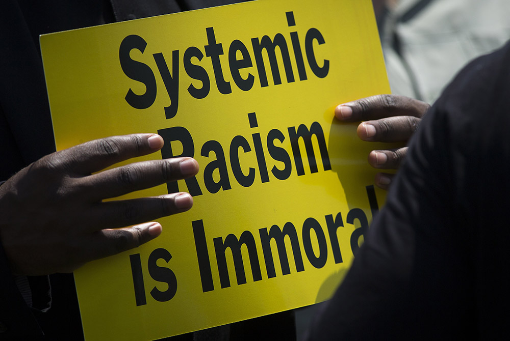 A protester is seen near the Capitol in Washington May 21, 2018, during an anti-racism demonstration. In remarks Nov. 16, during the U.S. bishops' virtual fall meeting, Deborah Amato, National Advisory Council chair, urged the bishops to continue to look A protester is seen near the Capitol in Washington May 21, 2018, during an anti-racism demonstration. In remarks Nov. 16, during the U.S. bishops' virtual fall meeting, Deborah Amato, National Advisory Council chair, urged the bishops to continue to look