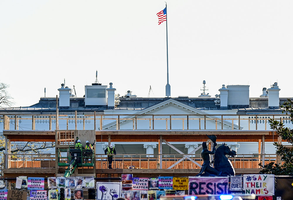 Workers construct a viewing stand in front of the White House Nov. 28, 2020, ahead of the presidential inauguration ceremonies Jan. 20, 2021, in Washington. (CNS/Reuters/Erin Scott)