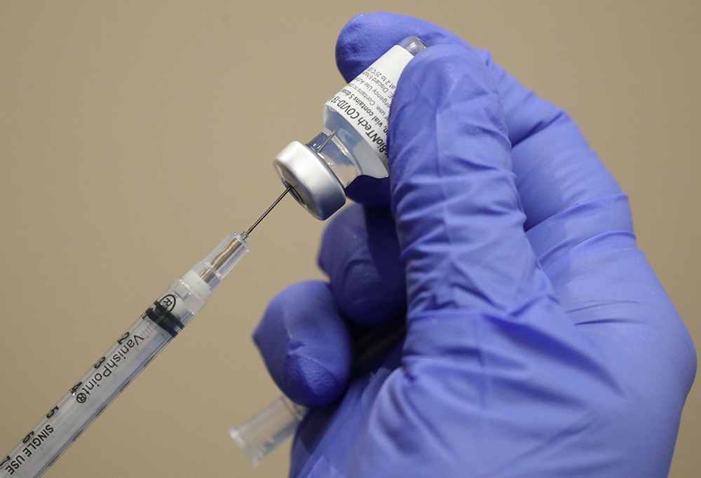 A health care worker at Dignity Health Glendale Memorial Hospital and Health Center in Glendale, California, draws the COVID-19 vaccine from a vial Dec. 17, 2020. (CNS/Reuters/Lucy Nicholson)