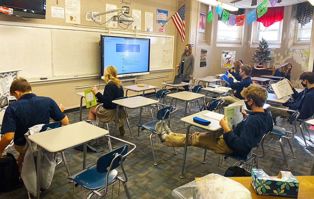 Teacher Melissa Pinkney instructs students during a Spanish class at Thomas More Prep-Marian Jr./Sr. High School in Hays, Kansas, Dec. 3, 2020. The school was in a hybrid model, with half of the students in class and the other half connecting virtually.