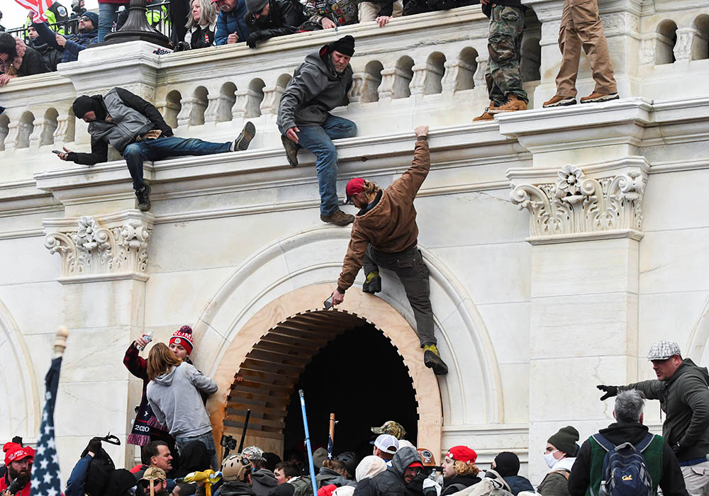 Supporters of President Donald Trump climb on walls at the U.S. Capitol in Washington Jan. 6, 2021, during a protest against Congress certifying the 2020 presidential election. (CNS/Stephanie Keith, Reuters) Supporters of President Donald Trump climb on walls at the U.S. Capitol in Washington Jan. 6, 2021, during a protest against Congress certifying the 2020 presidential election. (CNS/Stephanie Keith, Reuters)