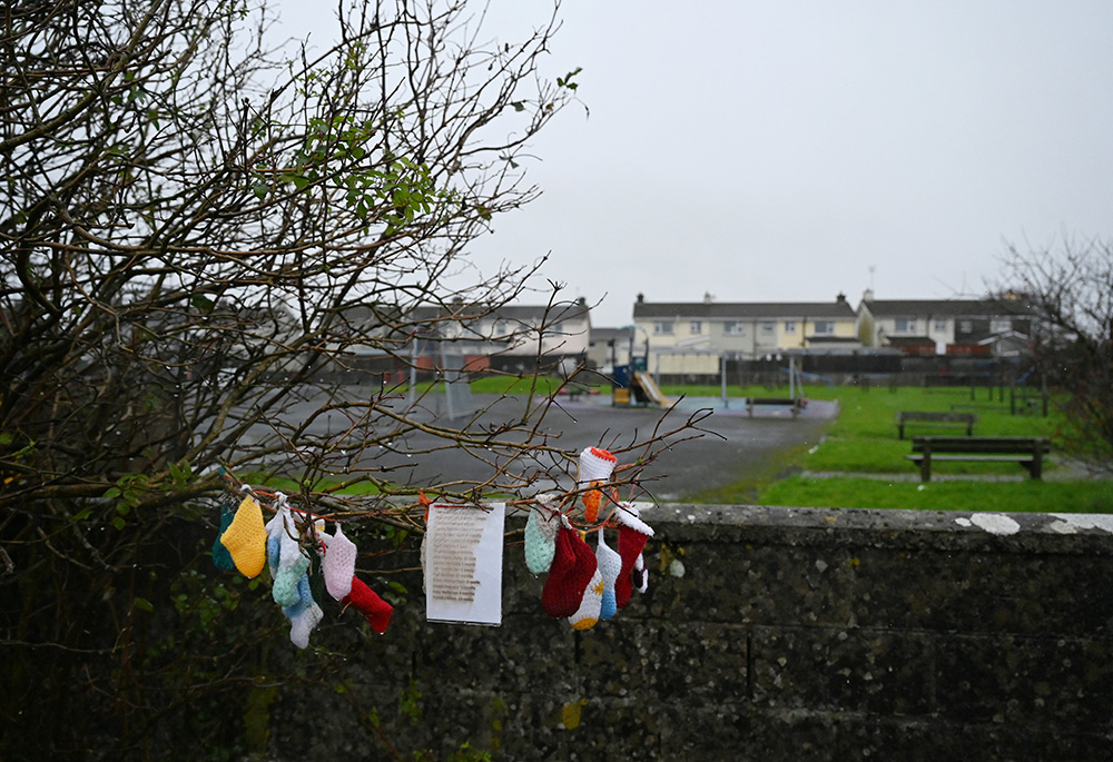 Baby clothing and other items hang from a tree at a cemetery in Tuam, Ireland, where the bodies of nearly 800 infants were uncovered at the site of a former Catholic home for unmarried mothers and their children. (CNS/Reuters/Clodagh Kilcoyne)