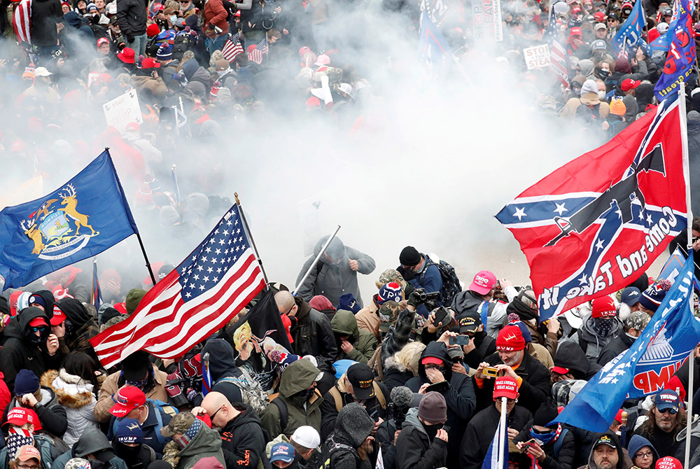 Tear gas is released into a crowd of demonstrators protesting the 2020 election results at the U.S. Capitol Jan. 6 in Washington. (CNS/Shannon Stapleton, Reuters) Tear gas is released into a crowd of demonstrators protesting the 2020 election results at the U.S. Capitol Jan. 6 in Washington. (CNS/Shannon Stapleton, Reuters)