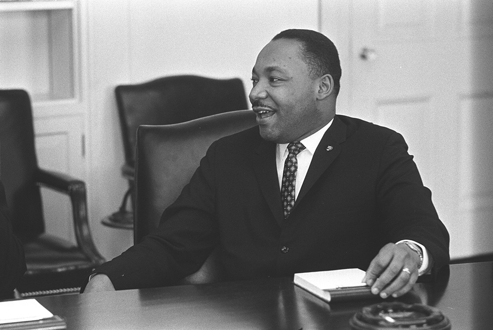 Civil rights leader the Rev. Martin Luther King Jr. smiles during a talk with U.S. President Lyndon B. Johnson, not pictured, in this undated photo. The federal holiday that celebrates the iconic civil rights leader is observed Jan. 18. (CNS/Yoichi Okamot