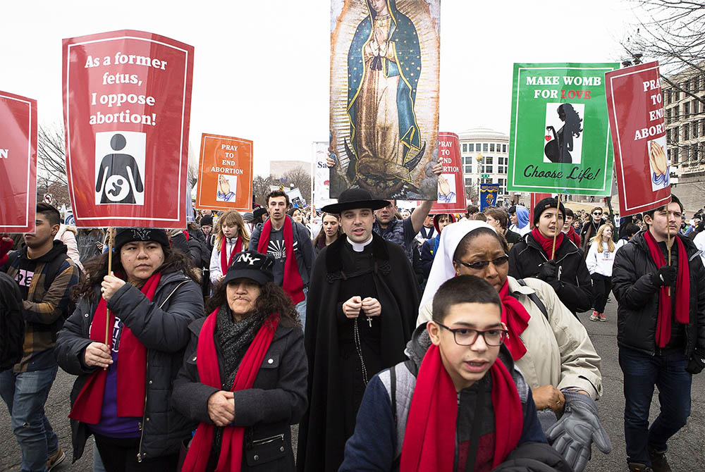 People walk up Constitution Avenue headed toward the U.S. Supreme Court while participating in the 47th annual March for Life Jan. 24, 2020, in Washington. The 2021 March for Life in Washington will be held virtually because of the coronavirus pandemic an People walk up Constitution Avenue headed toward the U.S. Supreme Court while participating in the 47th annual March for Life Jan. 24, 2020, in Washington. The 2021 March for Life in Washington will be held virtually because of the coronavirus pandemic an