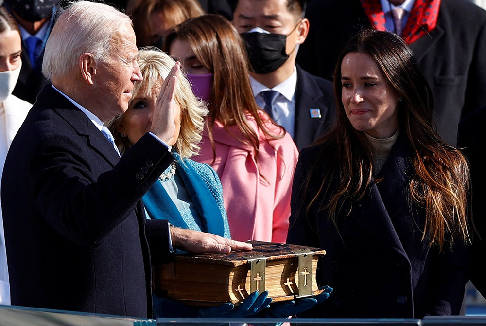 Joe Biden is sworn in as the 46th president of the United States by Chief Justice John Roberts as Biden's wife, Jill, holds the family Bible during his inauguration Jan. 20 at the Capitol in Washington. (CNS/Jim Bourg, Reuters)