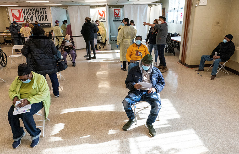 Residents of William Reid Apartments in the Brooklyn borough of New York City rest for a few minutes after receiving the first dose of the COVID-19 vaccine Jan. 23. (CNS/Mary Altaffer, Pool via Reuters) Residents of William Reid Apartments in the Brooklyn borough of New York City rest for a few minutes after receiving the first dose of the COVID-19 vaccine Jan. 23. (CNS/Mary Altaffer, Pool via Reuters)