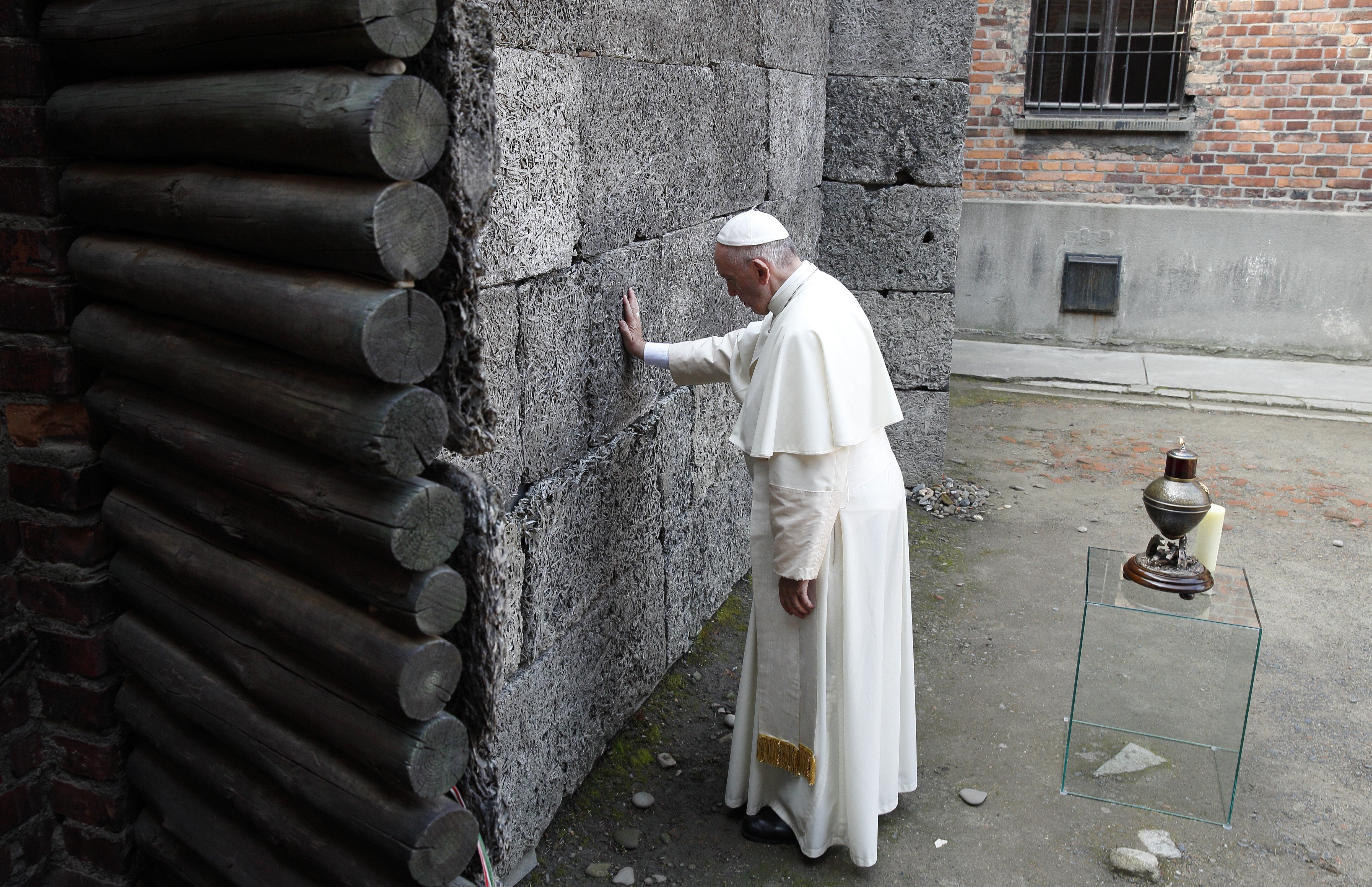 Pope Francis touches the death wall at the Auschwitz Nazi death camp in Oswiecim, Poland, in this July 29, 2016, file photo. (CNS/Paul Haring)