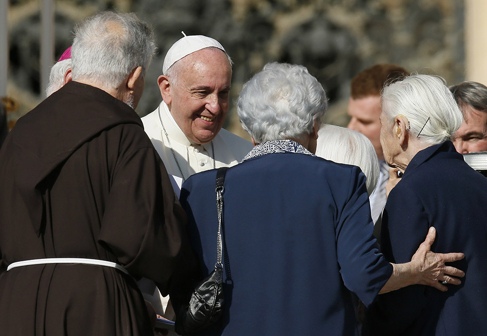 Pope Francis greets people during an encounter with the elderly in St. Peter's Square at the Vatican Sept. 28, 2014. (CNS/Paul Haring)