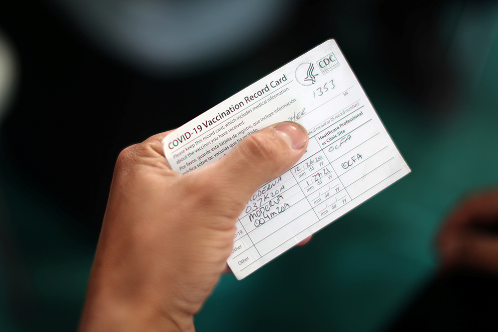 An Orange County firefighter in Irvine, California, holds his vaccination card after receiving the coronavirus vaccine Jan. 27. (CNS/Reuters/Lucy Nicholson) An Orange County firefighter in Irvine, California, holds his vaccination card after receiving the coronavirus vaccine Jan. 27. (CNS/Reuters/Lucy Nicholson)