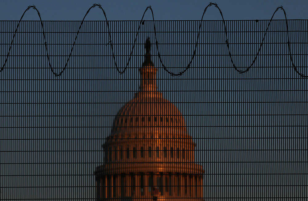 The U.S. Capitol is seen in Washington Jan. 28 behind steel fencing topped with razor wire. (CNS/Reuters/Leah Millis) The U.S. Capitol is seen in Washington Jan. 28 behind steel fencing topped with razor wire. (CNS/Reuters/Leah Millis)