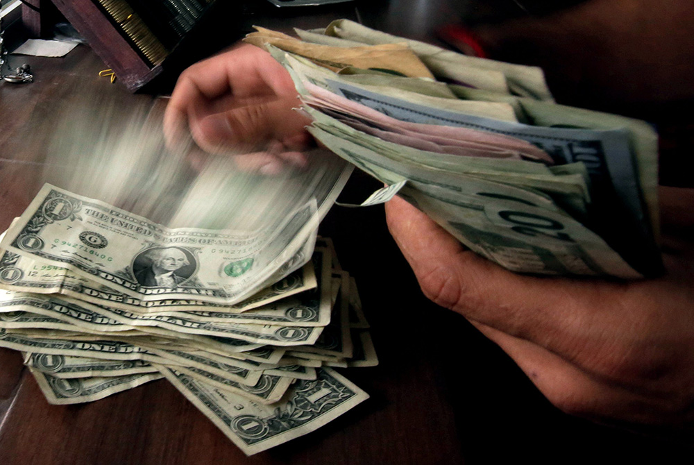 U.S. dollars are seen in this illustration photo. (CNS/Jose Luis Gonzalez, Reuters) U.S. dollars are seen in this illustration photo. (CNS/Jose Luis Gonzalez, Reuters)
