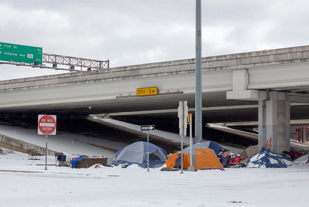 A homeless encampment is pictured under a highway overpass Feb. 16, 2020, during a winter storm in Austin, Texas. Austin planned to operate over a dozen warming shelters around the clock for the city's vulnerable population until the historic cold outbrea