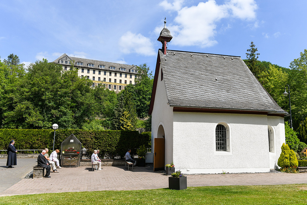 Pilgrims pray in front of the original Schonstatt Shrine in Vallendar, Germany, May 21, 2020. German Bishop Stephan Ackermann of Trier has ordered the reexamination of abuse allegations against Fr. Joseph Kentenich, founder of the Schonstatt movement, fro