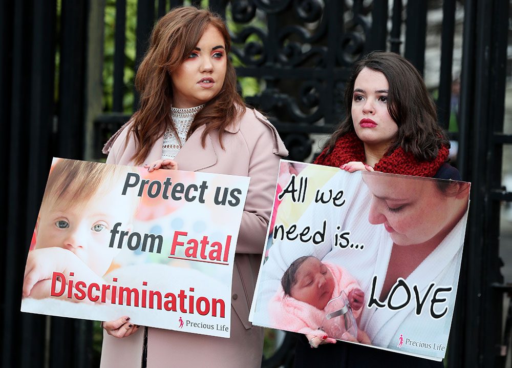 Pro-life supporters are pictured holding signs outside the High Court in Belfast, Northern Ireland, Jan. 30, 3019. (CNS/Reuters/Brian Lawless)