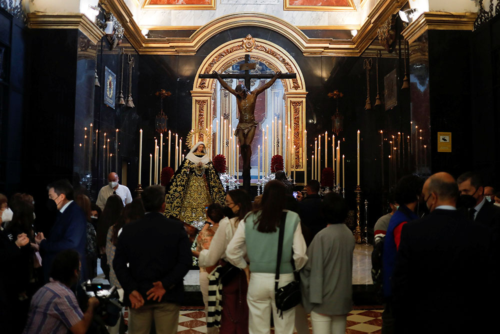 People take photos on Holy Thursday, April 1, inside a church in Malaga, Spain, after Holy Week processions were canceled during the coronavirus pandemic. (CNS/Reuters/Jon Nazca)