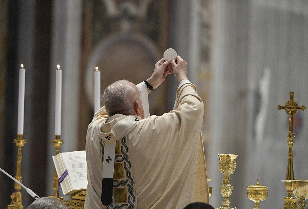 Pope Francis elevates the Eucharist during Easter Mass in St. Peter's Basilica at the Vatican April 4. (CNS/Vatican Media)