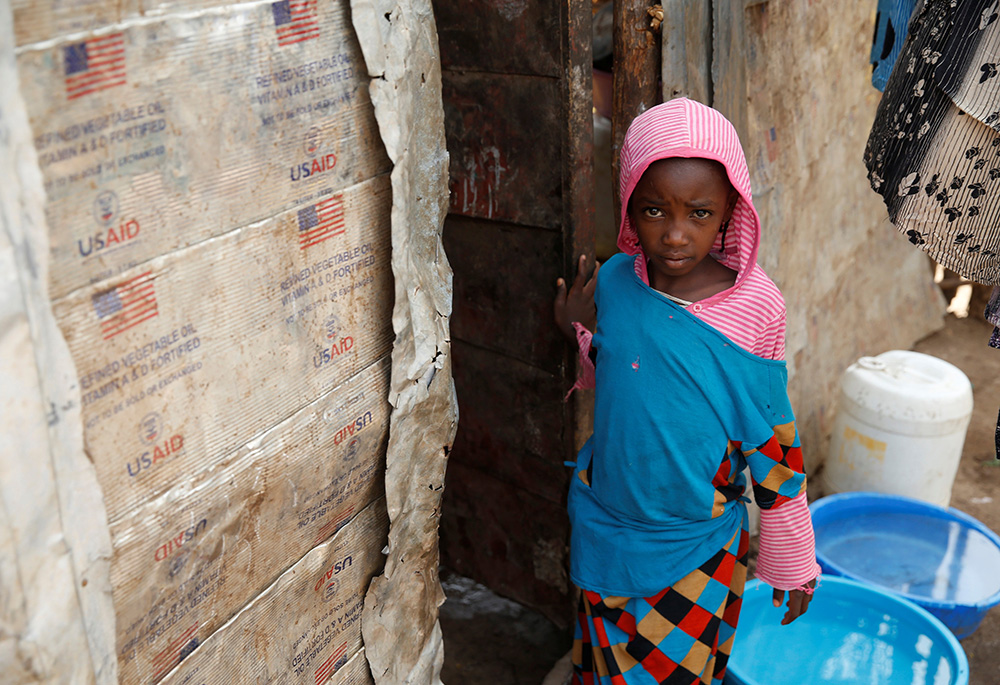 A girl stands outside a makeshift shelter in 2018 at the Kakuma refugee camp in northern Kenya. (CNS/Reuters/Baz Ratner)