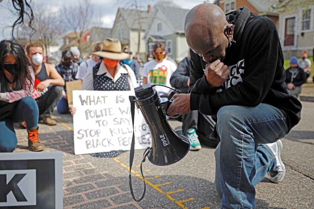 Demonstrators in St. Paul, Minnesota, kneel for a moment of silence April 18, after learning of another police-involved shooting elsewhere in the U.S. The march was held the weekend before closing arguments in the Derek Chauvin trial and as protests conti Demonstrators in St. Paul, Minnesota, kneel for a moment of silence April 18, after learning of another police-involved shooting elsewhere in the U.S. The march was held the weekend before closing arguments in the Derek Chauvin trial and as protests conti