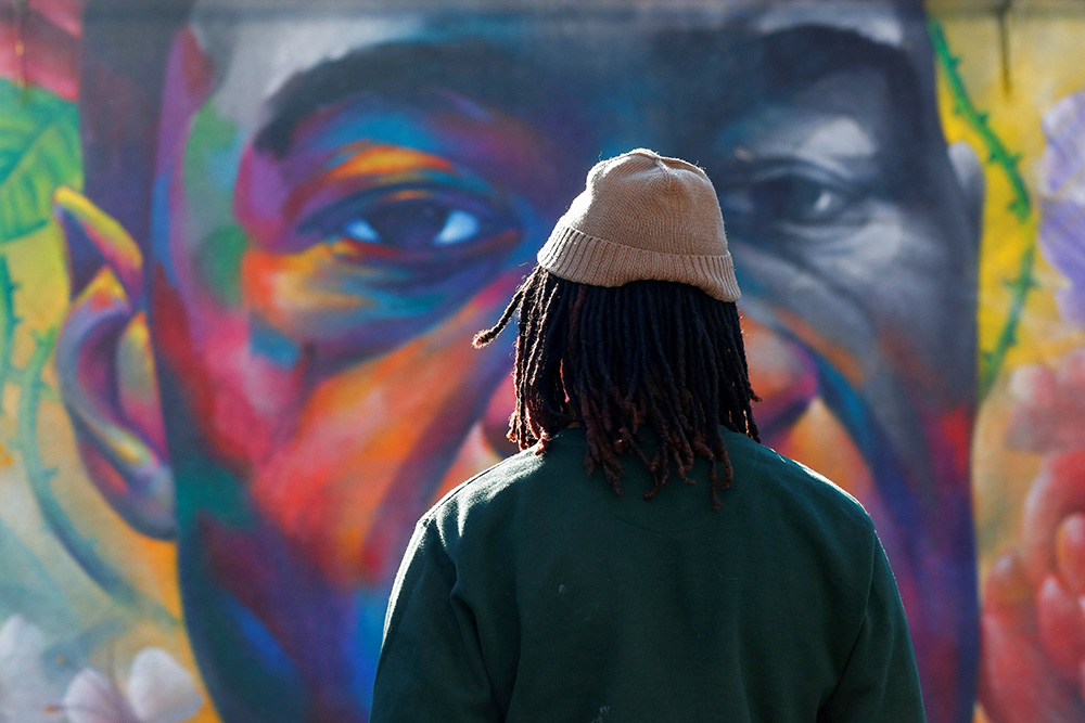 A person in Denver is seen at a George Floyd mural April 20 after jurors issued their verdict convicting former Minneapolis police officer Derek Chauvin of second-degree unintentional murder, third-degree murder and second-degree manslaughter. (CNS) A person in Denver is seen at a George Floyd mural April 20 after jurors issued their verdict convicting former Minneapolis police officer Derek Chauvin of second-degree unintentional murder, third-degree murder and second-degree manslaughter. (CNS)