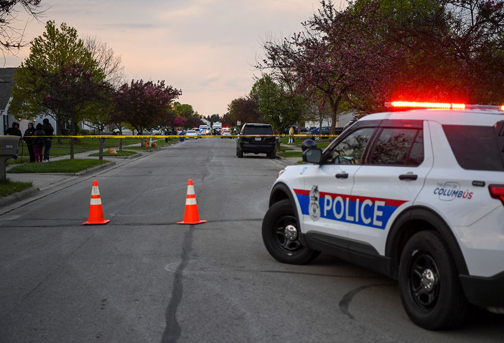 Investigators work at the scene where Ma'Khia Bryant, a 16-year-old Black girl, was fatally shot by a police officer April 20. (CNS/Reuters/Gaelen Morse)