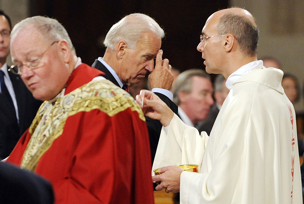 U.S. Vice President Joe Biden makes the sign of the cross after receiving Communion during a Mass at the Basilica of the National Shrine of the Immaculate Conception in Washington in this Sept. 14, 2011, file photo. (CNS/Leslie E. Kossoff)