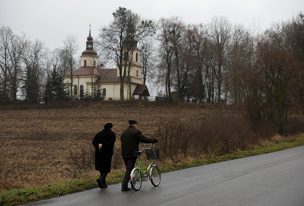 People in Kalinowka, Poland, walk to Mass in a file photo. (CNS/Reuters/Kacper Pempel)