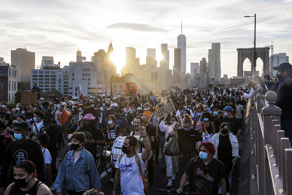 People in New York City march on the Brooklyn Bridge during a demonstration May 25, 2021, on the first anniversary of the death of George Floyd. (CNS/Reuters/Jeenah Moon)