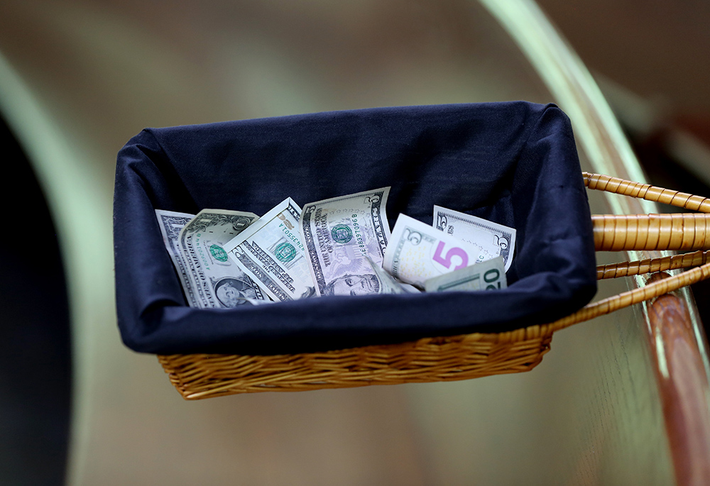 A collection basket with donations is seen in this illustration. (CNS/Bob Roller)