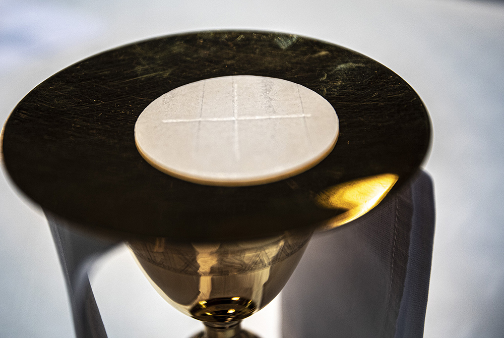 The Eucharist rests on a paten on an altar in a cathedral. (CNS/Chaz Muth)