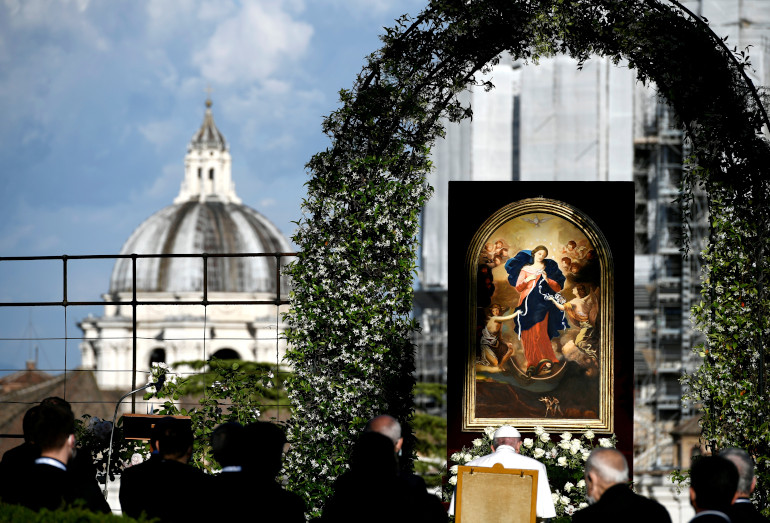 Pope Francis, seated before an image of Our Lady, Undoer of Knots, leads an evening Marian prayer service in the Vatican Gardens May 31. (CNS/Filippo Monteforte, Reuters pool)