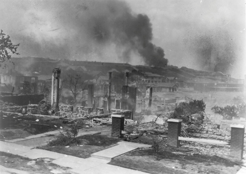 Smoke rises from the ruins of African Americans' homes following the 1921 race massacre in Tulsa, Oklahoma. (CNS/Library of Congress, Handout via Reuters/National Association for the Advancement of Colored People Records/Alvin C. Krupnick Co.)