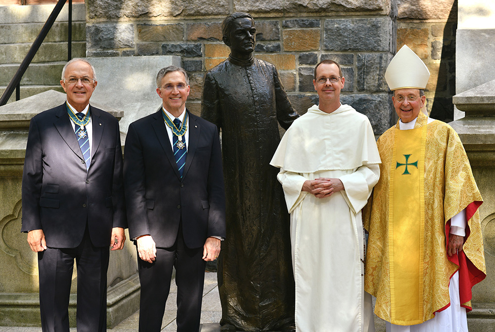 Supreme Knight Patrick Kelly, second from left, stands with retired Supreme Knight Carl Anderson, Fr. John Paul Walker, pastor of St. Mary's Church in New Haven, Conn., and Baltimore Archbishop William Lori after Mass June 11, 2021. (CNS)