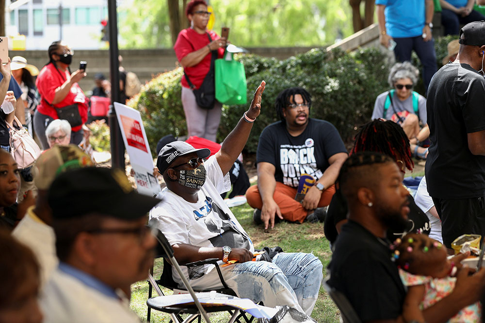 People in Atlanta listen a speech June 21 during a stop on the Black Voters Matter organization's Freedom Ride for Voting Rights. The voter outreach tour was making stops in several Southern states on its way to Washington. (CNS/Reuters/Dustin Chambers)