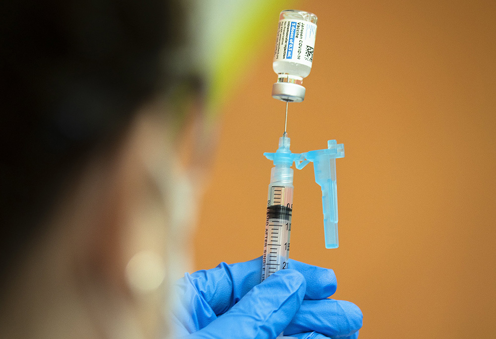 A health care worker at Catholic Charities in Washington prepares to administer the Johnson & Johnson COVID-19 vaccine May 18. (CNS/Tyler Orsburn)