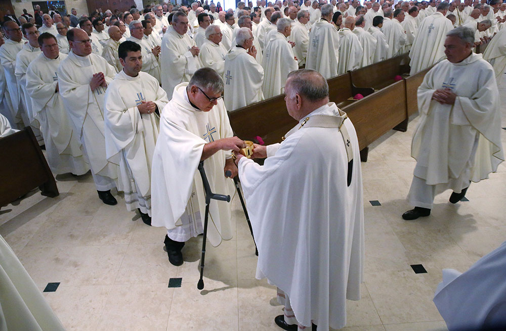 Miami Archbishop Thomas Wenski distributes Communion during Mass at St. Pius X Catholic Church during the U.S. Conference of Catholic Bishops' 2018 spring assembly in Fort Lauderdale, Florida. (CNS/Bob Roller) Miami Archbishop Thomas Wenski distributes Communion during Mass at St. Pius X Catholic Church during the U.S. Conference of Catholic Bishops' 2018 spring assembly in Fort Lauderdale, Florida. (CNS/Bob Roller)